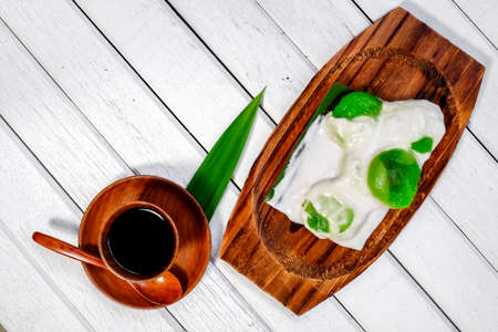 Badak berendam a local Malaysian dessert and cuf of coffee  on wooden backgroundの写真素材