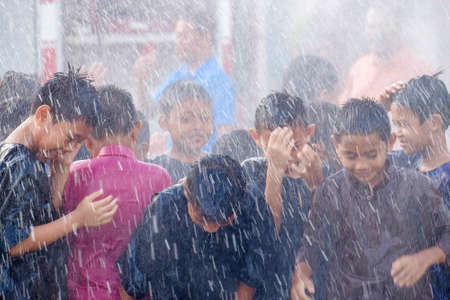 Muadzam Shah, Malaysia -  November 24th  , 2018 : Childrens wearing traditional malay costume are happy to play the water during the flush event of the circumcision participants.のeditorial素材