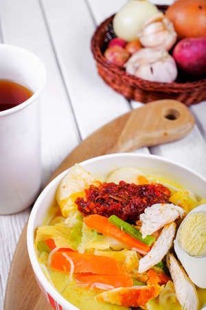 Lontong-Traditional Malaysian and   Indonesian food on wooden table with spoon.の写真素材