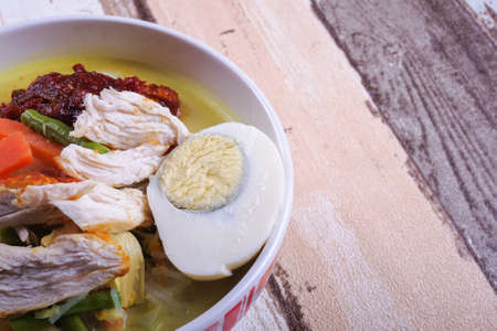 Lontong-Traditional Malaysian and   Indonesian food on wooden table .の写真素材