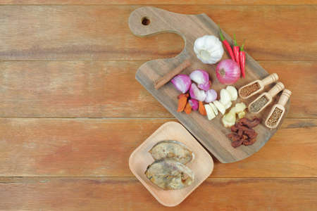 Skip jack tuna, onion, tumeric, chili,  herbs and garlic on cutting board. Ready to cook.の写真素材