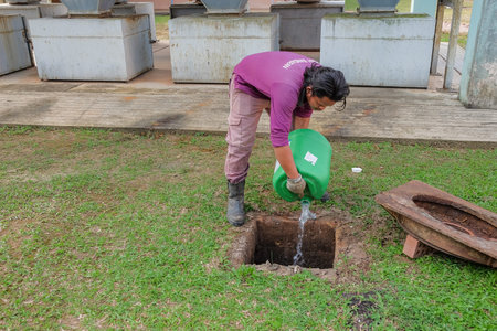 Muadzam Shah, Malaysia - January 3rd, 2019 : The worker clears the clogged sewer drain using a...