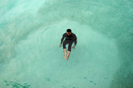 Perhentian  Island , Malaysia - August 15th, 2018 :Top view of sea diver  in a water suit is swimming with   fishのeditorial素材
