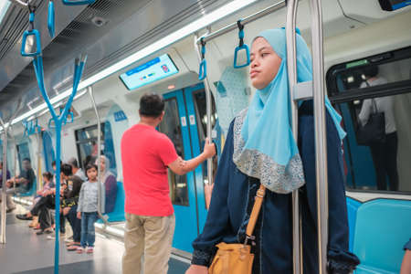 KUALA LUMPUR, MALAYSIA - December 31th,  2017: Passengers inside Mass Rapid Transit MRT train . MRT is Mass Rapid Transit Corporation Sdn Bhd, in Kuala Lumpur, M`alaysia.のeditorial素材