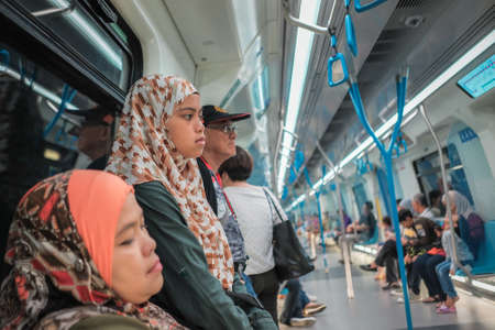 KUALA LUMPUR, MALAYSIA - December 31th,  2017: Passengers inside Mass Rapid Transit MRT train . MRT is Mass Rapid Transit Corporation Sdn Bhd, in Kuala Lumpur, M`alaysia.のeditorial素材