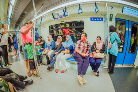 KUALA LUMPUR, MALAYSIA - December 31th,  2017: Passengers inside Mass Rapid Transit MRT train . MRT is Mass Rapid Transit Corporation Sdn Bhd, in Kuala Lumpur, M`alaysia.のeditorial素材
