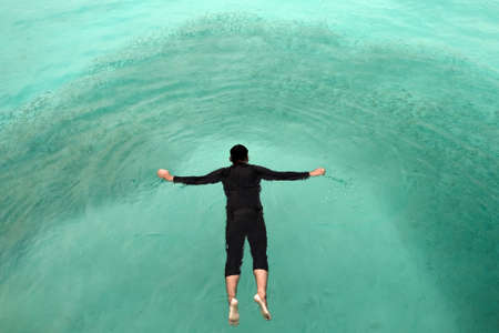 Top view of sea diver  in a water suit is swimming with   fishの写真素材