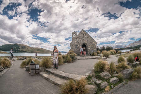 Lake Tekapo, New Zealand â December 16th, 2017 :  Visitors from around the world were enjoying view of lake and church at lake Tekapo in the afternoon.のeditorial素材