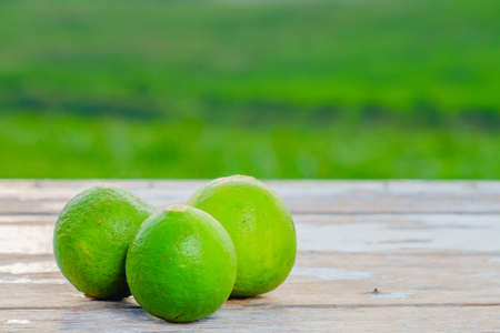 Limes  on old wooden with blurred background ,healthy nutrition,strengthening immunity and dietの写真素材