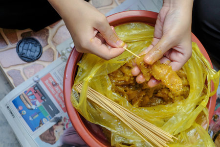 Kota Bharu, Malaysia- June 14th, 2018 : The process of cooking and making traditional food satay...
