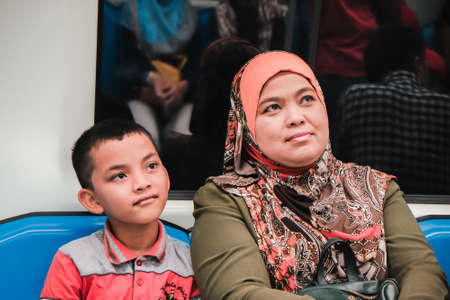 KUALA LUMPUR, MALAYSIA - December 31th,  2017: Passengers inside Mass Rapid Transit MRT train . MRT is Mass Rapid Transit Corporation Sdn Bhd, in Kuala Lumpur, M`alaysia.のeditorial素材
