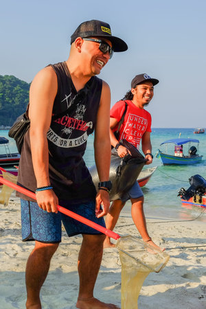 Pulau Perhentian, Terengganu - August 14th, 2018  : Group of volunteers tidying up rubbish on beach...