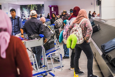 Sepang, Malaysia - Disember 21st, 2017 : Passengers collecting luggage at conveyor belt in Kuala...