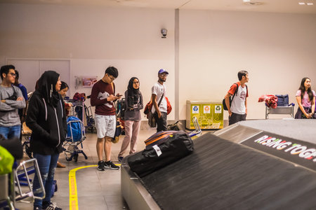 Sepang, Malaysia - Disember 21st, 2017 : Passengers collecting luggage at conveyor belt in Kuala...