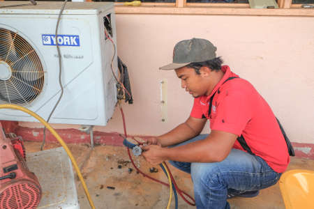 Muadzam Shah, Malaysia - May 15th, 2019 : Air conditioning technician checking,repairing and maintenance at Kolej Vokasional Muadzam Shah, Malaysia.のeditorial素材
