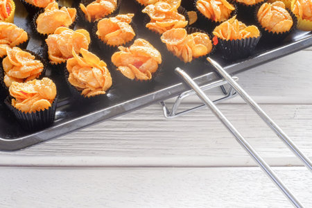 Corn flakes cup in  oven tray over the wooden tableの写真素材