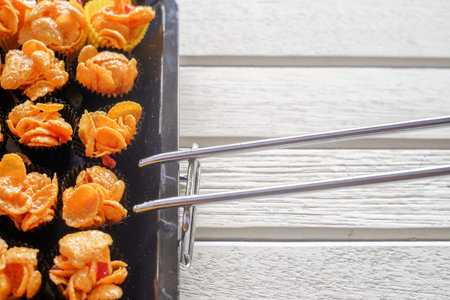 Corn flakes cup in  oven tray over the wooden table