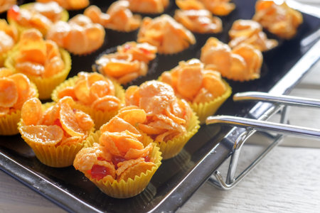Corn flakes cup in  oven tray over the wooden table
