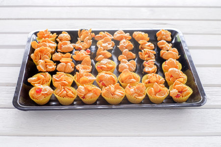 Corn flakes cup in  oven tray over the wooden table