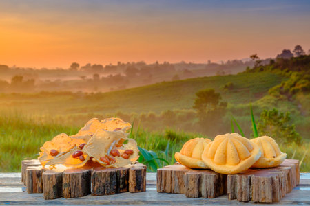 Malaysia traditional sweet as known as Baulu or Bahulu and Rempeyek on wooden block during beautiful...