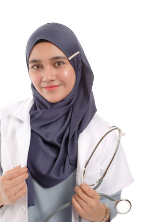 Beautiful Muslimah doctor holding a stethoscope isolated in white backgroundの写真素材