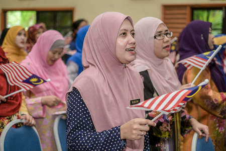 Muadzam Shah, Malaysia - August 8th, 2019 : Malaysian college students with Malaysian Flag during the celebration of Hari Kemerdekaan, the Independence Day of Malaysia.のeditorial素材