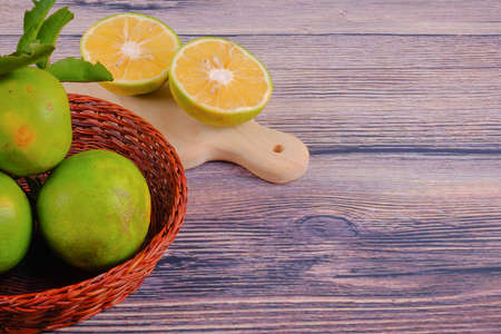 Citrus fruits with green leaves isolated on wood backgroundの写真素材