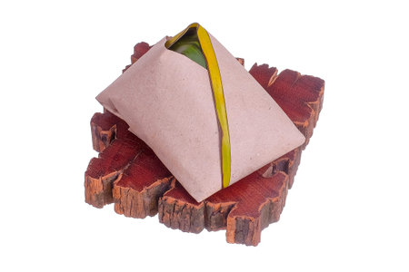 Nasi Lemak or Spicy Rice . Nasi lemak is a traditional Malay rice cooked in coconut milk with pandan leaf .  Wrapped in banana leaf with spicy chili sambal,fried anchovies,egg.cucumber slice and peanutの写真素材