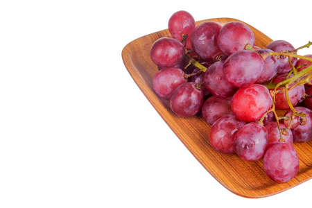 Fresh bunch of grapes on plate isolated on white backgroundの写真素材