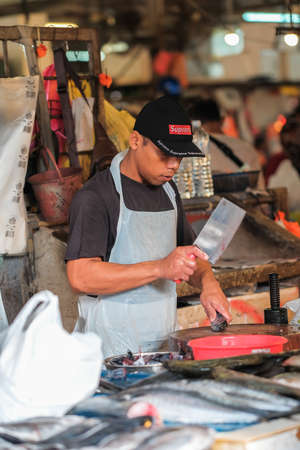 Kuala Lumpur, Malaysia - December 2nd, 2019 :  A wet market selling different colorful fishes with people buying in the morning .のeditorial素材
