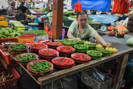Kuala Lumpur, Malaysia - December 2nd, 2019 :  Vegetable vendor at a market in the morning .のeditorial素材
