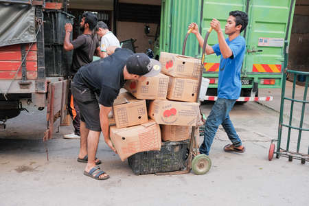 Kuala Lumpur, Malaysia - December 2nd, 2019 :  Street sellers of Pasar Chow Kit . Most of the street sellers use trolley to sell their product like vegetables, fruits,flowers or other tools needed at home.のeditorial素材