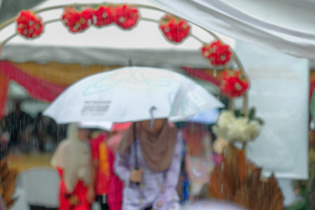 People with umbrella walking down the street in heavy rainy day. Intentional motion blur. Soft...
