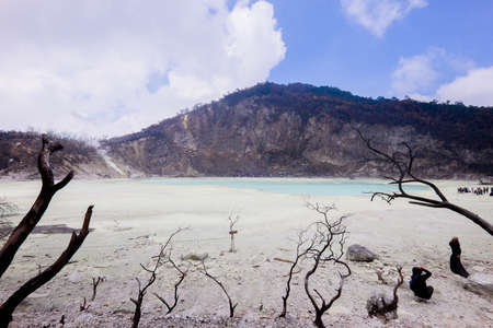 Beautiful panorama of The White Crater (or Kawah Putih), Ciwidey, Bandung, Indonesia. Ciwidey White Crater is a lake, the land mixed with sulfur around the crater makes it white.の写真素材