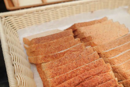 Lots of fresh bread in a basket on a tableの写真素材