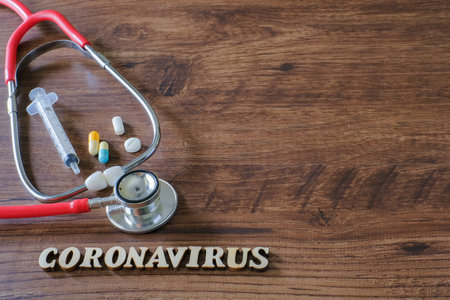 Text phrase Coronavirus on wooden background with medical equipment . Novel coronavirus 2019-nCoV...