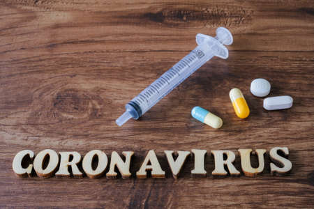 Text phrase Coronavirus on wooden background with medical equipment . Novel coronavirus 2019-nCoV middle East respiratory syndrome coronavirus.の写真素材