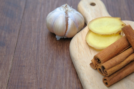 Ginger, garlic, cinnamon on wooden table