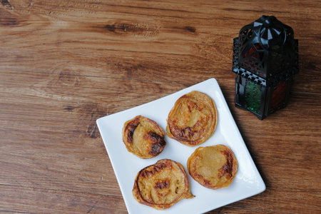 Malaysian desert called Akok Kedut on white plate.