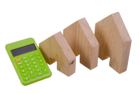 Wooden block house and calculator isolated on white backgroundの写真素材