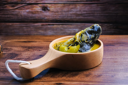 kan Patin Masak Tempoyak in wooden  pot Ikan.  Patin Tempoyak is a famous Malaysian heritage dish...