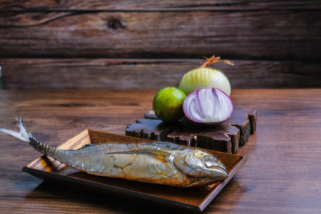 Cencaru Bakar Sumbat Sambal in Malay or grilled fish  and onion , garlic, tomato and lime on a...