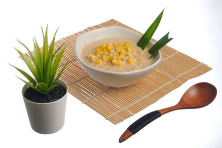 Corn porridge  in white bowl isolated on white backgroundの写真素材