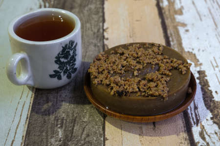 Traditional cookies in Malaysia during Hari Raya Festival known as Kuih Kole Kacang with  and tea  on the wooden backgroundの写真素材