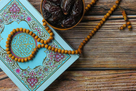 Quran Kareem , wooden rosary , SAFAWI  dates on wooden backgroundの写真素材