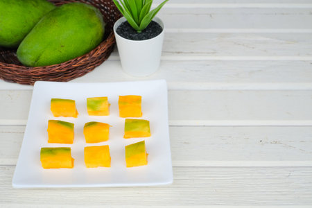 Sliced mango fruit on wooden background. Healthy Foodの写真素材