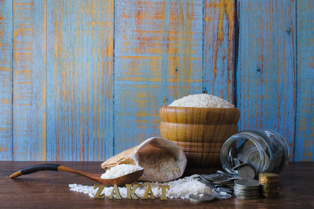 ZAKAT word, coin stacked , and rice. Zakat Concept. Zakat is the sharing of wealth from the rich for...