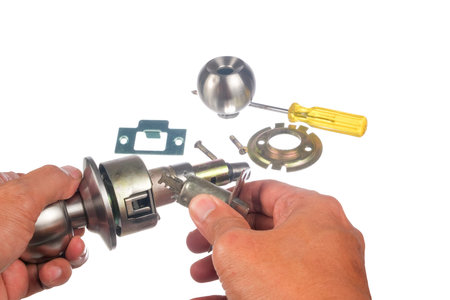 The closeup of worker hands assembling door knob isolated on white background.