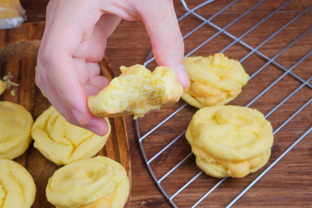 Close up view of girl making cream puff on wooden table