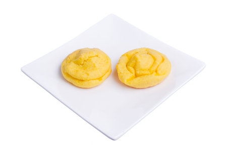 Cream puff cakes with custard on white plate isolated on white background